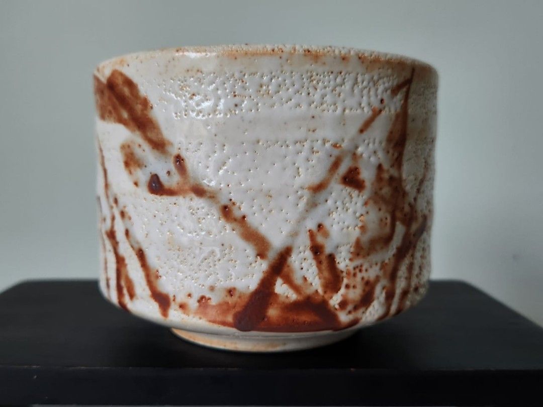 Japanese Style Ceramic Bowl with Rustic Glaze (Category: Vases & Decorative Bowls) located in Kuala Lumpur. Submitted by gentlepenguin.6b8aad (Listing ID 1450150638, Image 1). Description: - Handcrafted ceramic bowl - Unique textured glaze with brown abstract markings - Dimensions: Approx. 4 inches height, 5 inches diameter - Perfect for tea ceremonies or as a decorative accent - Features a maker's mark on the bottom.