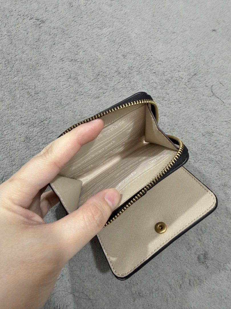 Kate Spade New York Bi-Fold Wallet (Category: Wallets & Card holders) located in Manila. Submitted by moobrava (Listing ID 1450245510, Image 3). Description: - Authentic Kate Spade New York wallet - Stylish beige and black color block design - Convenient bi-fold style with secure snap closure - Interior features multiple card slots and a zippered pocket for essentials - Elegant gold hardware details - Compact and practical for daily use.