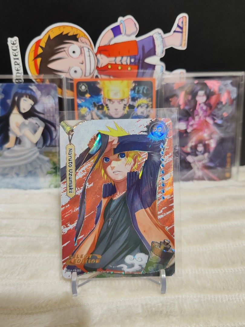 Kayou Naruto PR Cards (Category: Raw Singles) located in Makati City. Submitted by wisemanshop (Listing ID 1450301909, Image 1). Description: English Select Edition PR Card - Holographic Naruto Uzumaki anime trading card - Features a vibrant and eye-catching design - Ideal for collectors and fans of the Naruto series - Other anime cards available (One Piece, Hinata) - Card is protected in a sleeve for safekeeping.