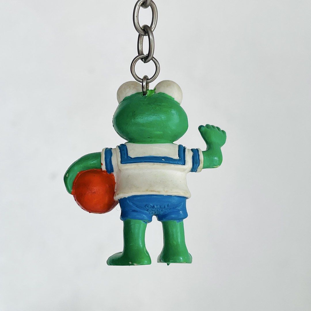Kermit the Frog Muppet Babies Keychain (Category: Character Goods) located in Cabuyao City. Submitted by nyannyancore (Listing ID 1450179876, Image 3). Description: - Adorable green frog keychain - Dressed in a cute sailor outfit - Holding a small orange ball - Frog is waving - Great accessory for bags or keys - Fun and charming little item.