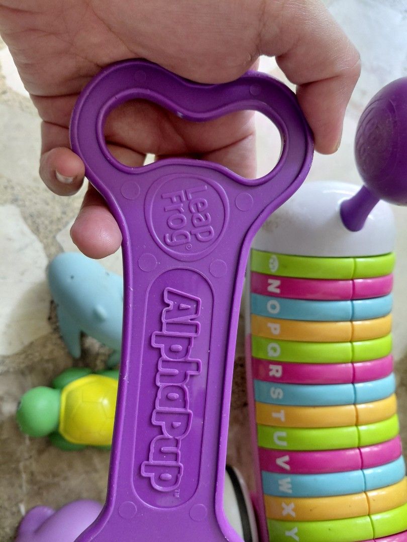 LeapFrog AlphaPup Learning Toy Dog with Pull String (Category: Educational & Learning Toys) located in Pasig City. Submitted by aaa-choooo (Listing ID 1450146007, Image 2). Description: LEAP FROG ALPHA PUP TOY - Pull-along dog teaches letters and words - still working well. it's just full of scratches because my kid pulled it along like a real dog.🤣 - ‼️FREE‼️ - 4 bath toys - 2 knee pads - 2 cars.