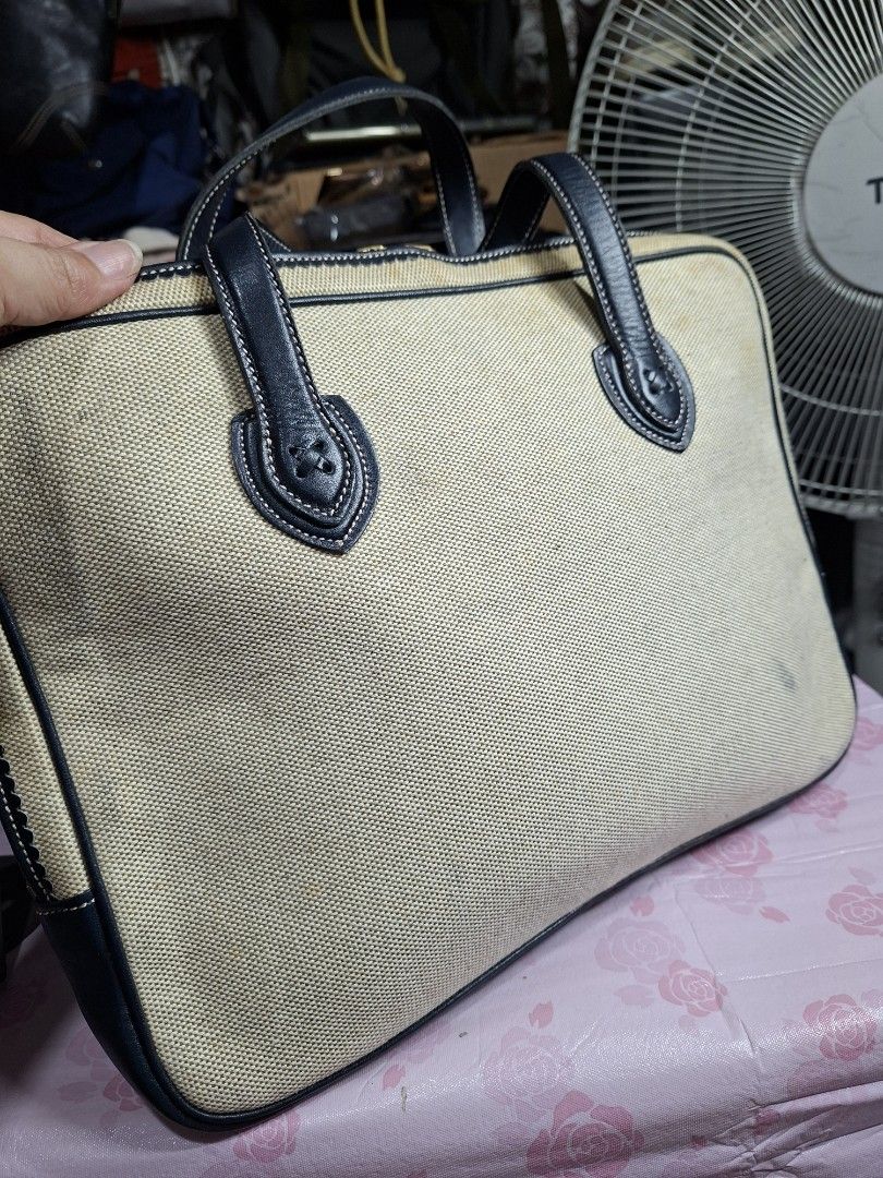 Loewe Canvas Tote Bag with Leather Trim (Category: Luxury Bags & Wallets) located in Lucena. Submitted by dai_suki (Listing ID 1450320409, Image 3). Description: - Loewe canvas tote bag - Navy leather trim and handles - Embroidered Loewe anagram on front - Canvas exterior has some marks and stains - Spacious interior - Ideal for everyday use.