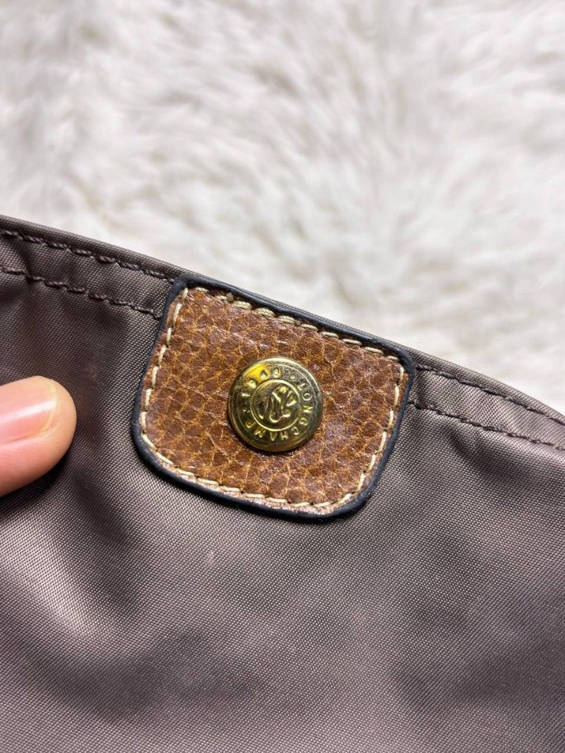 Longchamp Le Pliage Pouch Brown (Category: Purses & Pouches) located in Catbalogan. Submitted by kristinapi (Listing ID 1450136683, Image 2). Description: - Authentic Brown Longchamp Pouch - Classic design with leather trim - Secure snap button closure - Zippered main compartment - Ideal for organizing makeup, coins, or small essentials - Compact and portable for everyday use - sign of usage (see last photo).