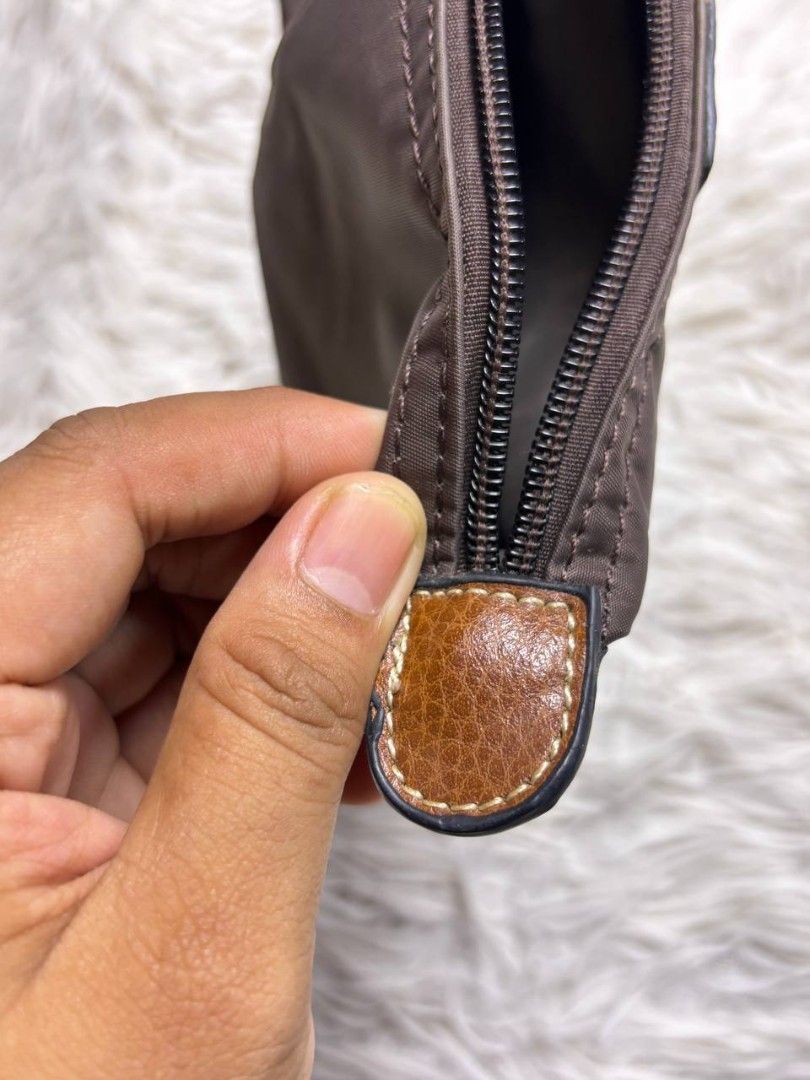 Longchamp Le Pliage Pouch Brown (Category: Purses & Pouches) located in Catbalogan. Submitted by kristinapi (Listing ID 1450136683, Image 3). Description: - Authentic Brown Longchamp Pouch - Classic design with leather trim - Secure snap button closure - Zippered main compartment - Ideal for organizing makeup, coins, or small essentials - Compact and portable for everyday use - sign of usage (see last photo).