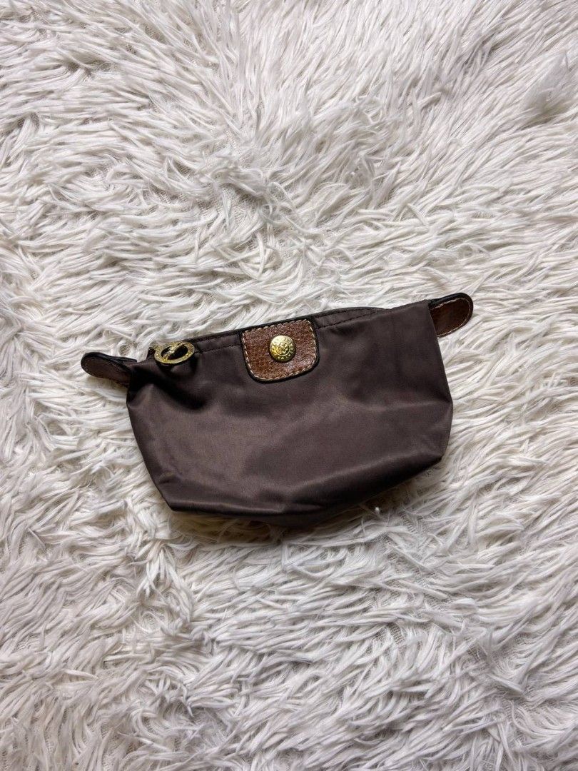 Longchamp Le Pliage Pouch Brown (Category: Purses & Pouches) located in Catbalogan. Submitted by kristinapi (Listing ID 1450136683, Image 1). Description: - Authentic Brown Longchamp Pouch - Classic design with leather trim - Secure snap button closure - Zippered main compartment - Ideal for organizing makeup, coins, or small essentials - Compact and portable for everyday use - sign of usage (see last photo).