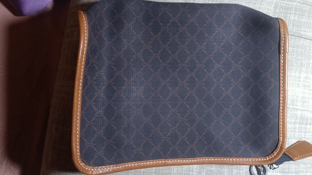 Longchamp Pouch Dark Blue with Brown Leather Trim (Category: Purses & Pouches) located in Rizal. Submitted by simplygoodthingsmel (Listing ID 1450278360, Image 2). Description: - brown pouch with a repeating pattern - Brown leather trim around the edges - Zipper closure with a metal charm - Tan interior lining - Ideal for organizing essentials.