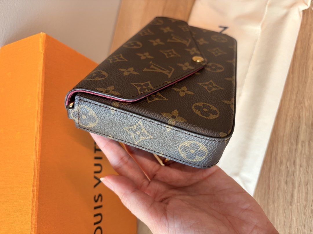 Louis Vuitton Monogram Felicie Pochette (Category: Luxury Bags & Wallets) located in Makati City. Submitted by tempting_closet (Listing ID 1450281243, Image 2). Description: - Classic Louis Vuitton monogram clutch - Envelope style with gold snap button closure - Interior features a pop of pink - Comes with original box and dust bag - Ideal for carrying your essentials.