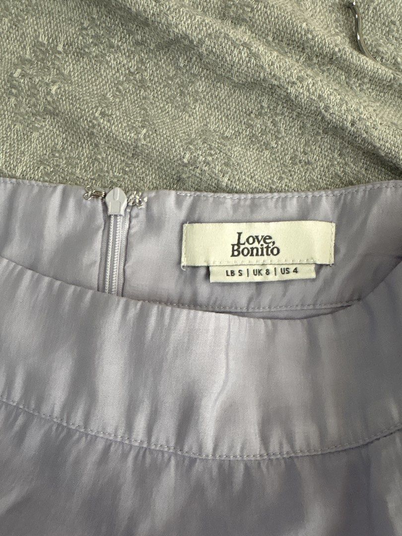 Love Bonito Skirt (Category: Skirts) located in Mandaluyong City. Submitted by xxtin (Listing ID 1450212020, Image 2). Description: - Light purple maxi skirt from Love Bonito - Features a tie waist - Front slit for added detail - Flowy, comfortable material - Perfect for dressing up or down, ideal for summer occasions Can send actual photos. Willing to swap for size medium any color..