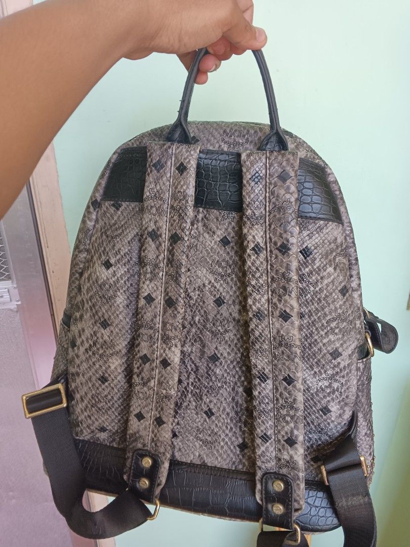 MCM Studded Snakeskin Backpack (Category: Luxury Bags & Wallets) located in Bayombong. Submitted by jnjthriftshop123 (Listing ID 1450147066, Image 3). Description: MCM backpack with a snakeskin pattern. Studded details all over. Black trim and straps. Zipper closure. Great for everyday use or travel. Issue: sign of use 📍Bayombong, Nueva Vizcaya.
