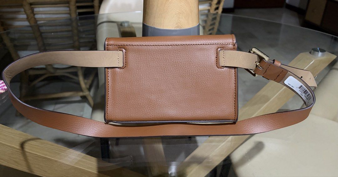 Michael Kors Brown Leather Belt Bag (Category: Luxury Bags & Wallets) located in Manila. Submitted by ejshop82 (Listing ID 1450282773, Image 2). Description: - Authentic Michael Kors brown leather belt bag - Features iconic MK logo on the front - Secure magnetic closure - Adjustable belt strap for a comfortable fit - Size L/XL - Perfect for hands-free convenience.