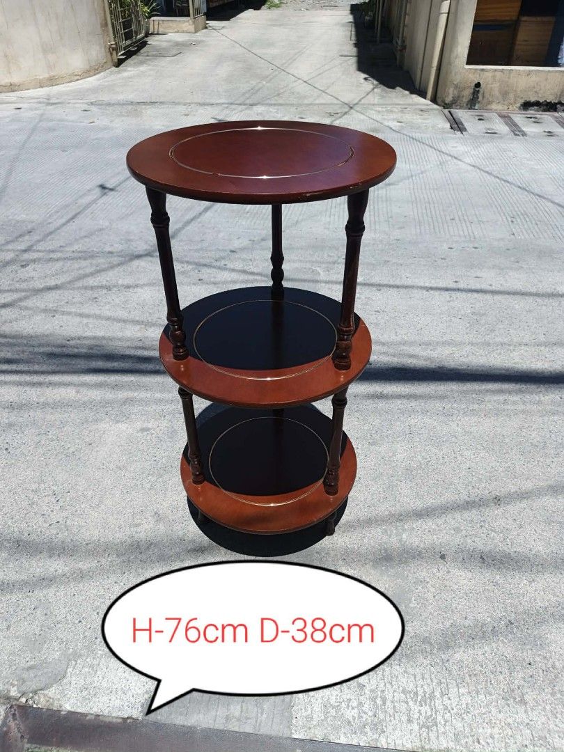 Mid century Wooden 3-Tier Round Side Table (Category: Tables & Sets) located in Valenzuela. Submitted by mariteskendra012917 (Listing ID 1450151817, Image 1). Description: - Elegant 3-tier round side table - Rich dark wood finish with contrasting lighter wood accents - Top and bottom tiers are solid wood - Middle tier features a dark wood insert - Ideal for holding drinks, books, plants, or decorative items - Dimensions: Height 76cm, Diameter 38c