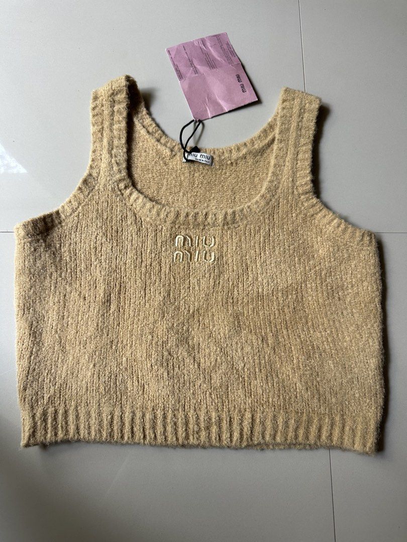 Miu Miu Tan Knit Cropped Tank Top (Category: Sleeveless) located in Rosales. Submitted by dariang22 (Listing ID 1450136613, Image 1). Description: - Miu Miu tan knit cropped tank top - Features embroidered Miu Miu logo on front - Made in Italy - Size 40 - Versatile for layering or standalone wear.