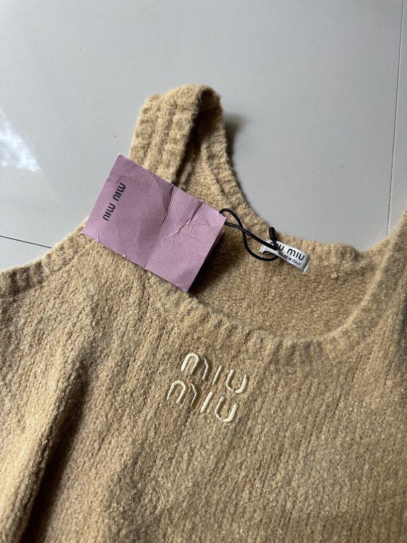 Miu Miu Tan Knit Cropped Tank Top (Category: Sleeveless) located in Rosales. Submitted by dariang22 (Listing ID 1450136613, Image 2). Description: - Miu Miu tan knit cropped tank top - Features embroidered Miu Miu logo on front - Made in Italy - Size 40 - Versatile for layering or standalone wear.