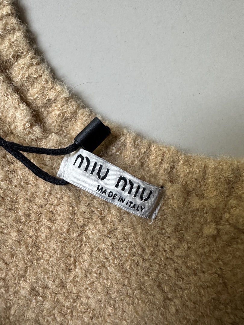 Miu Miu Tan Knit Cropped Tank Top (Category: Sleeveless) located in Rosales. Submitted by dariang22 (Listing ID 1450136613, Image 3). Description: - Miu Miu tan knit cropped tank top - Features embroidered Miu Miu logo on front - Made in Italy - Size 40 - Versatile for layering or standalone wear.