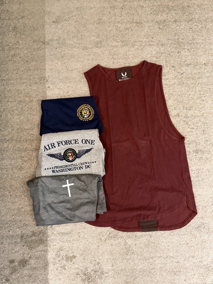 Muscle Tank Bundle (Category: Activewear) located in Manila. Submitted by decluttersiris (Listing ID 1450234760, Image 3). Description: - Bundle of 4 t-shirts, all size Medium. - Includes: Navy blue Presidential Seal tee, Grey Air Force One Presidential Crew shirt, Grey t-shirt with white cross, Maroon Aesthetic Revolution tank top. - Tank top material: 95% cotton, 5% spandex. - Ideal for everyday casual wear..