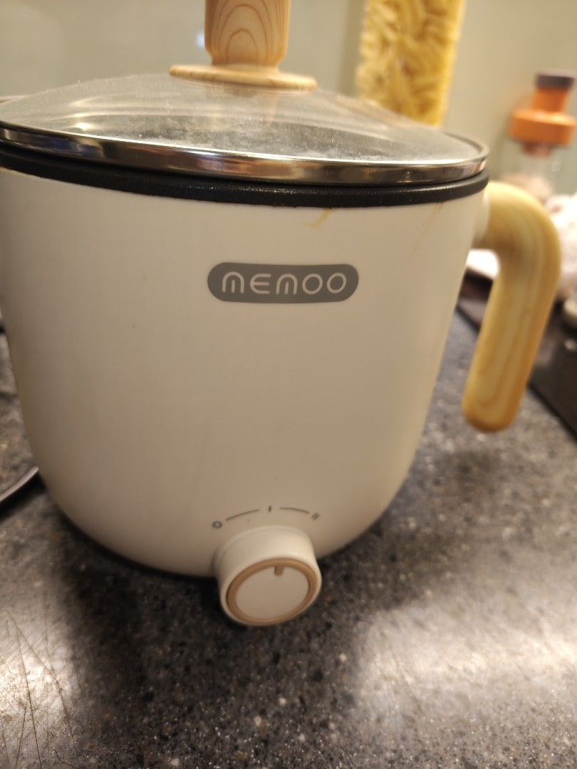 Nemoo Electric Pot with Glass Lid (Category: Cookware & Accessories) located in Kuala Lumpur. Submitted by rarovcdo (Listing ID 1450260185, Image 2). Description: - White Nemoo electric pot - Features a glass lid with a stylish wooden handle - Convenient wooden handle on the side for easy handling - Simple dial control for adjustable heat settings - Ideal for preparing quick meals, instant noodles, or boiling water - Compact design for easy stora