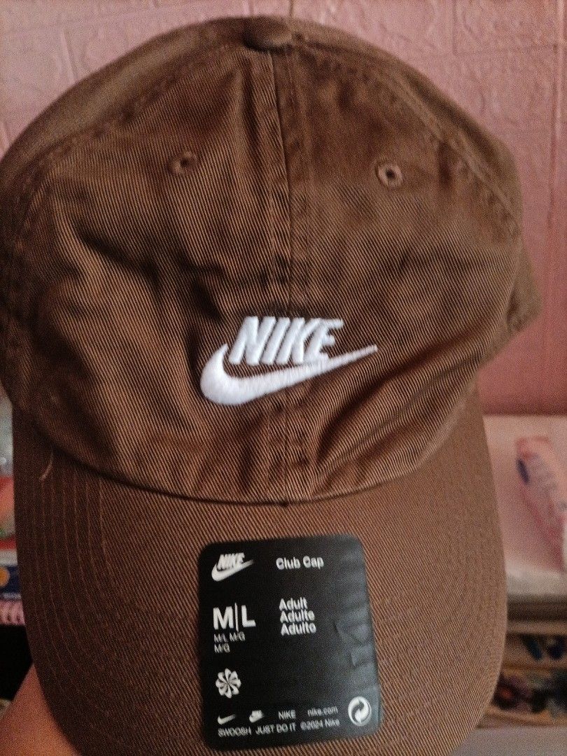 Nike Brown Baseball Cap M/L (Category: Caps & Hats) located in Bocaue. Submitted by michellesell_2 (Listing ID 1450121204, Image 2). Description: - Classic Nike baseball cap - Simple brown color - Iconic white Nike logo embroidered on the front - Adjustable strap at the back for a comfortable fit - Great for everyday wear or sports - BRAND NEW. MEGAMALL SHOP..