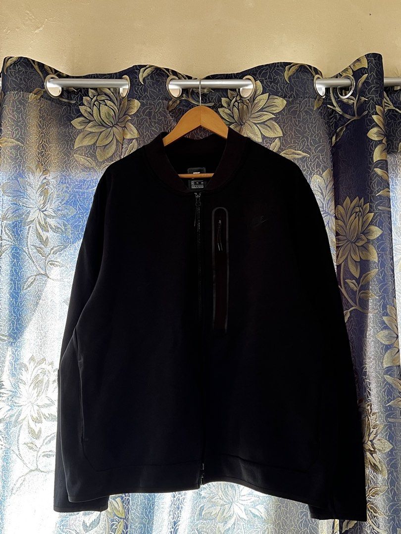 Nike Tech Fleece Bomber Jacket Black 2XL (Category: Coats, Jackets and Outerwear) located in Quezon City. Submitted by dayothrift_ph (Listing ID 1450194893, Image 1). Description: - Black Nike Tech Fleece bomber jacket - Size: 2XL - Full zip closure - Zippered chest pocket - Ribbed collar, cuffs, and hem - Subtle embroidered Nike logo on chest.