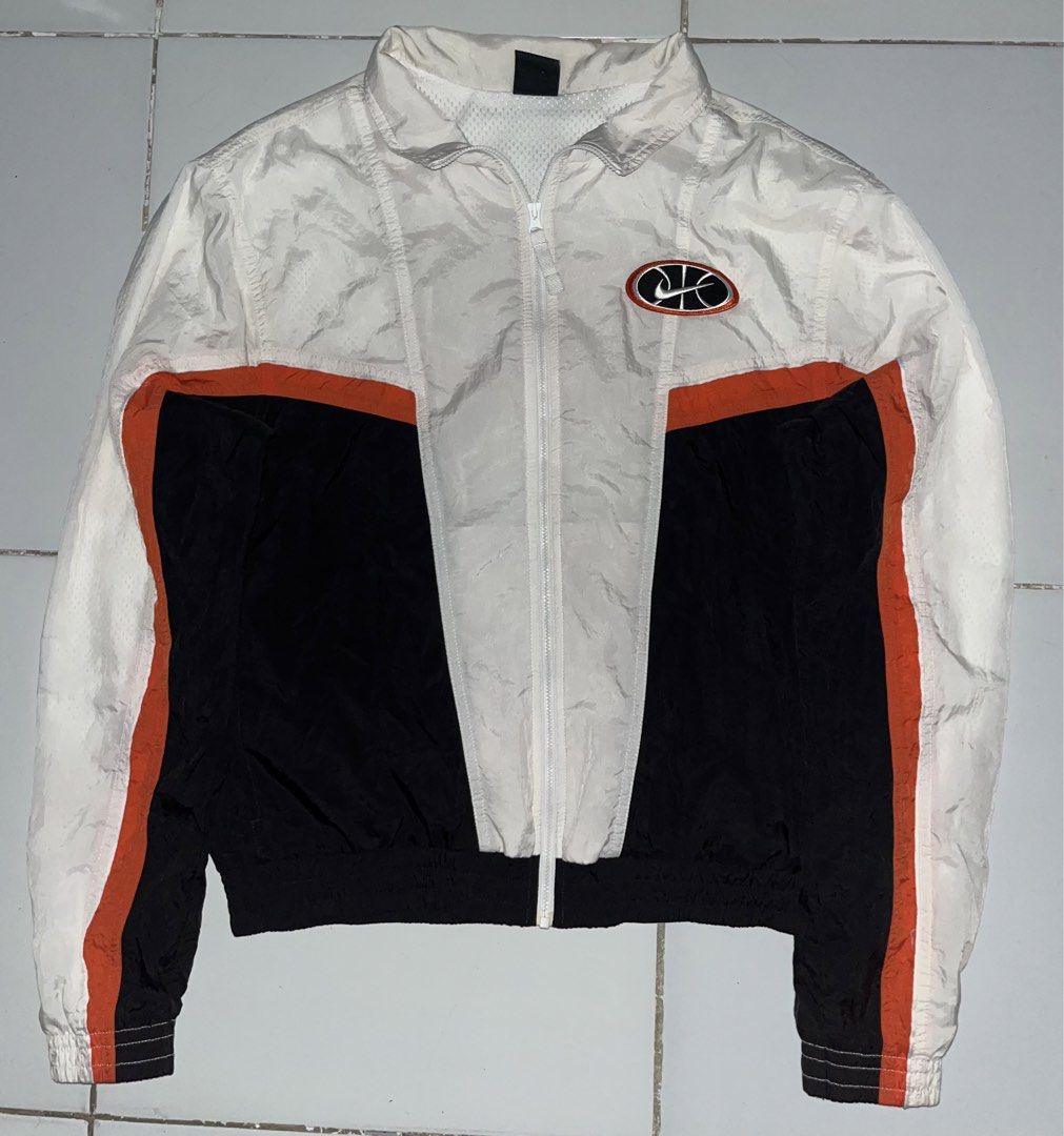 Nike Throwback Windbreaker Jacket (Category: Coats, Jackets and Outerwear) located in Cagayan de Oro. Submitted by curatedthrift.26 (Listing ID 1450231971, Image 1). Description: - Brand: Nike - Type: Throwback Windbreaker Jacket - Size: Medium (M) - Color: White, Black, and Orange color-block design - Features: Iconic Nike logo on chest and back, lightweight material - Style: Retro, sporty - negotiable.