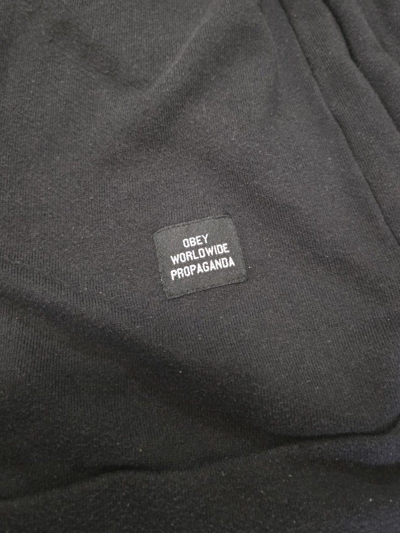 OBEY Worldwide Black Sweatshirt (Category: Coats, Jackets and Outerwear) located in Manila. Submitted by weirdlysa (Listing ID 1450199325, Image 3). Description: - OBEY sweatshirt - black color - men's size M - baggy, oversized fit - plain design with small "obey worldwide propaganda" patch in front.