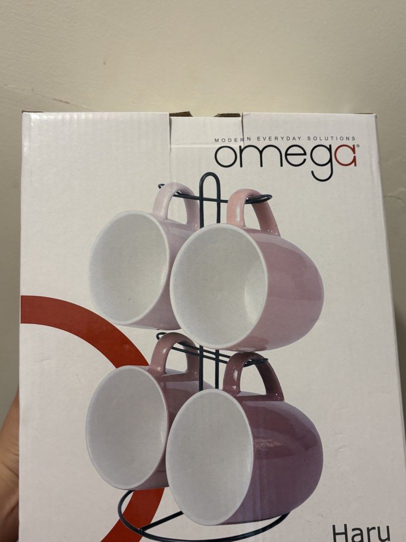 Omega Haru Mug Set with Rack - 4pcs (Category: Coffee & Tea Tableware) located in Dasmarinas. Submitted by twiceasnewph (Listing ID 1450213068, Image 1). Description: - Set of 4 Omega Haru mugs - Includes black metal rack - Two mugs in light pink - Two mugs in darker mauve - Ideal for coffee or tea - Original packaging included.
