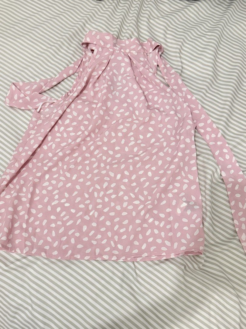 Pink White Ditsy Print Cold Shoulder Tie Top (Category: Blouses) located in Pasig City. Submitted by howdykoko (Listing ID 1450307645, Image 1). Description: - Adorable pink top with a charming white ditsy print. - Features a trendy cold shoulder design. - Stylish tie details at the shoulders for a customizable fit. - Estimated size: Small to Medium. - Versatile for casual day outs or evening gatherings. - Effortlessly pairs with jeans or shorts.