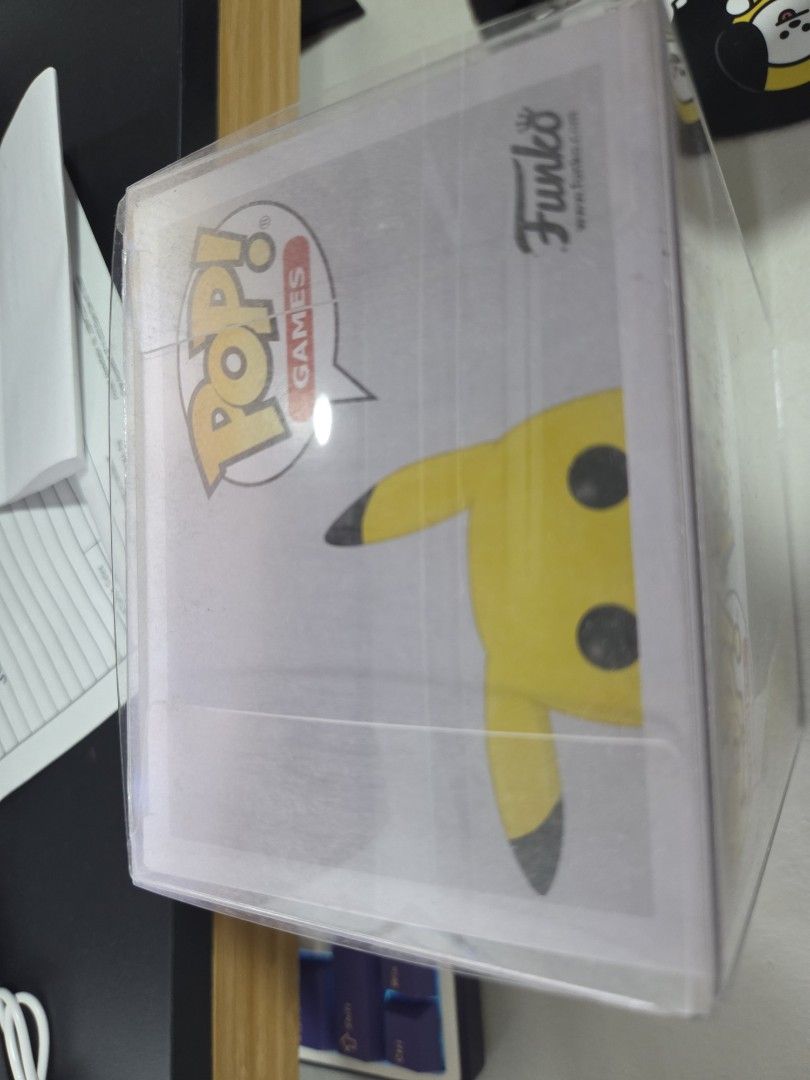 Pokemon Funko Pop (Pikachu) (Category: Designer & Blind Box Toys) located in Quezon City. Submitted by panchie32 (Listing ID 1450266457, Image 2). Description: Please refer to photo for item's condition. Note that item has an outer cover/case included. I do not open my Funko Pops. As soon as I got this, I placed it inside a protective outer cover and displayed it on my shelf. The figure itself has never been removed from the box or handled. 📍 Lo