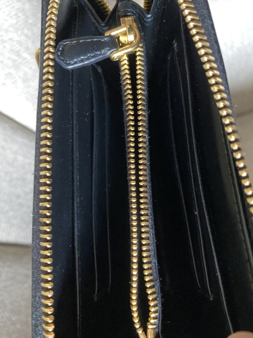 Prada Black Leather Zip Around Wallet (Category: Luxury Bags & Wallets) located in Pasig City. Submitted by greatlookforless (Listing ID 1450193790, Image 3). Description: - Authentic Prada wallet NEW ・With gold logo ・Round zipper closure ・2 gusseted compartments ・4 card pockets ・2 multi-pockets ・1 zippered coin purse ・1 back zippered pocket (one-sided gusset) ・Gold hardware - natural durable leather - Lampo special zipper Size Width 15cm x Heigh