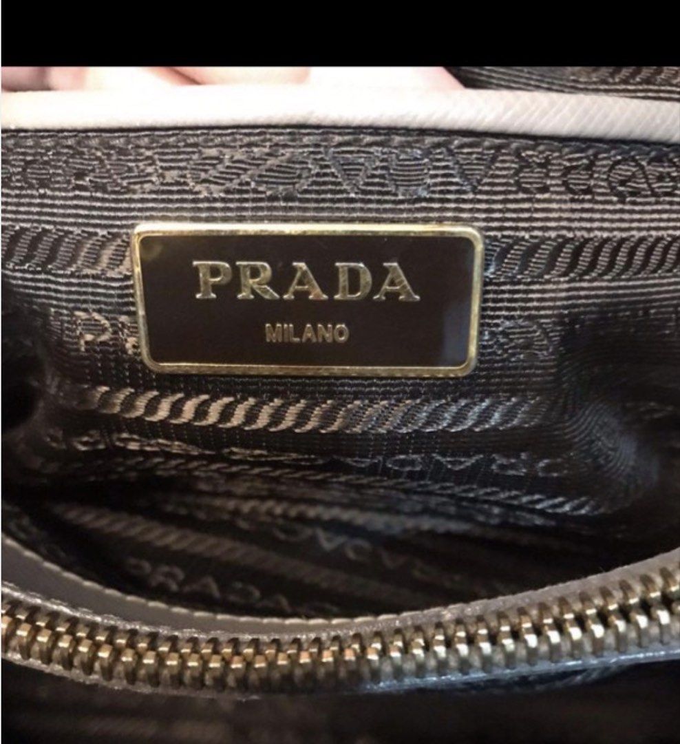 Prada Saffiano Leather Grey Top Handle Bag (Category: Luxury Bags & Wallets) located in Las Pinas. Submitted by CocoBebeBeautiQ (Listing ID 1450216001, Image 3). Description: Authentic Prada Saffiano leather bag grey color Detachable shoulder strap included Interior features Prada logo lining Comes with Entrupy certificate of authenticity tag 64 PAYMENT FIRST POLICY PASS TO LOW BALLER.