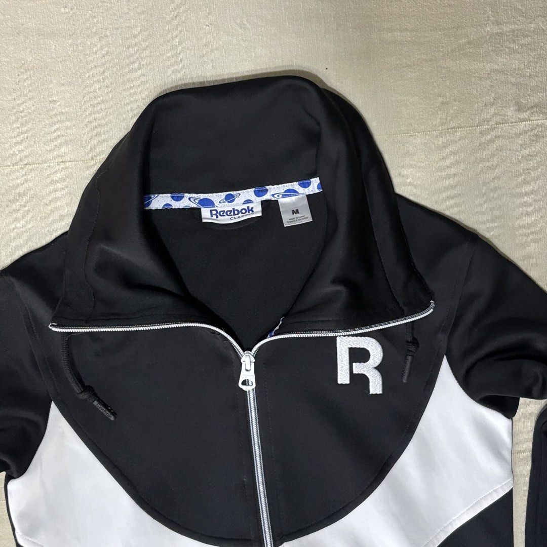 Reebok Black White Track/Running Jacket Zip Up Size M (Category: Coats, Jackets and Outerwear) located in Dasmarinas. Submitted by 8ocho8 (Listing ID 1450279387, Image 3). Description: - Reebok Track Jacket - Color: Black and White - Size: Medium (M) - Features: Full zip closure, front pockets - Collar: Can be zipped high or folded down - Ideal for: Casual wear, light workouts Measurements: W: 17in L: 24in Sleeve: 23in.
