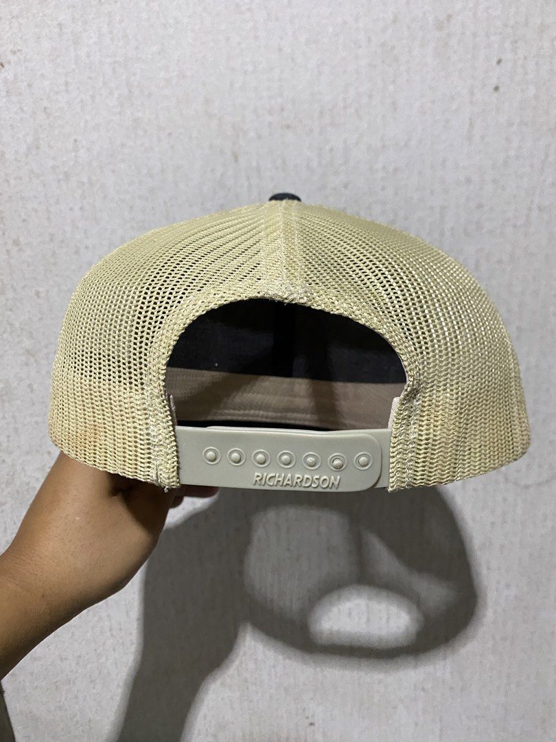 Richardson Peak to Plains Guide Service Trucker Hat (Category: Caps & Hats) located in Puerto Princesa. Submitted by earlpogitrhift (Listing ID 1450289910, Image 2). Description: - Black and tan trucker hat - Features a circular patch with 'Peak to Plains Guide Service' text and mountain graphic - Richardson brand with adjustable strap - Mesh back for breathability - Ideal for outdoor adventures.
