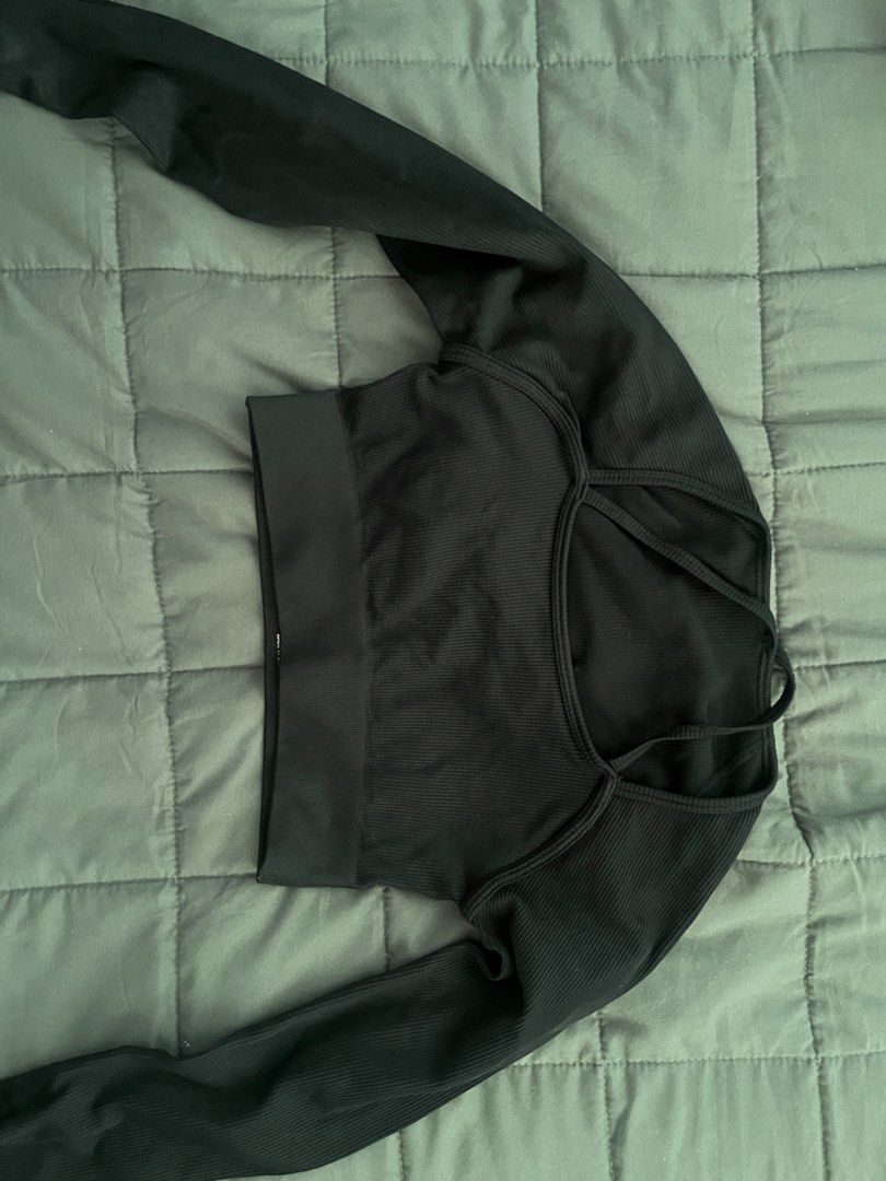 SHEIN Black Ribbed Long Sleeve Crop Top (Category: Activewear) located in Cavite. Submitted by Djbstuff (Listing ID 1450205993, Image 1). Description: - Chic black ribbed long sleeve crop top - Features a unique criss-cross detail at the back - Made with a comfortable and stretchy polyamide and elastane blend - Versatile for workouts or casual everyday wear.