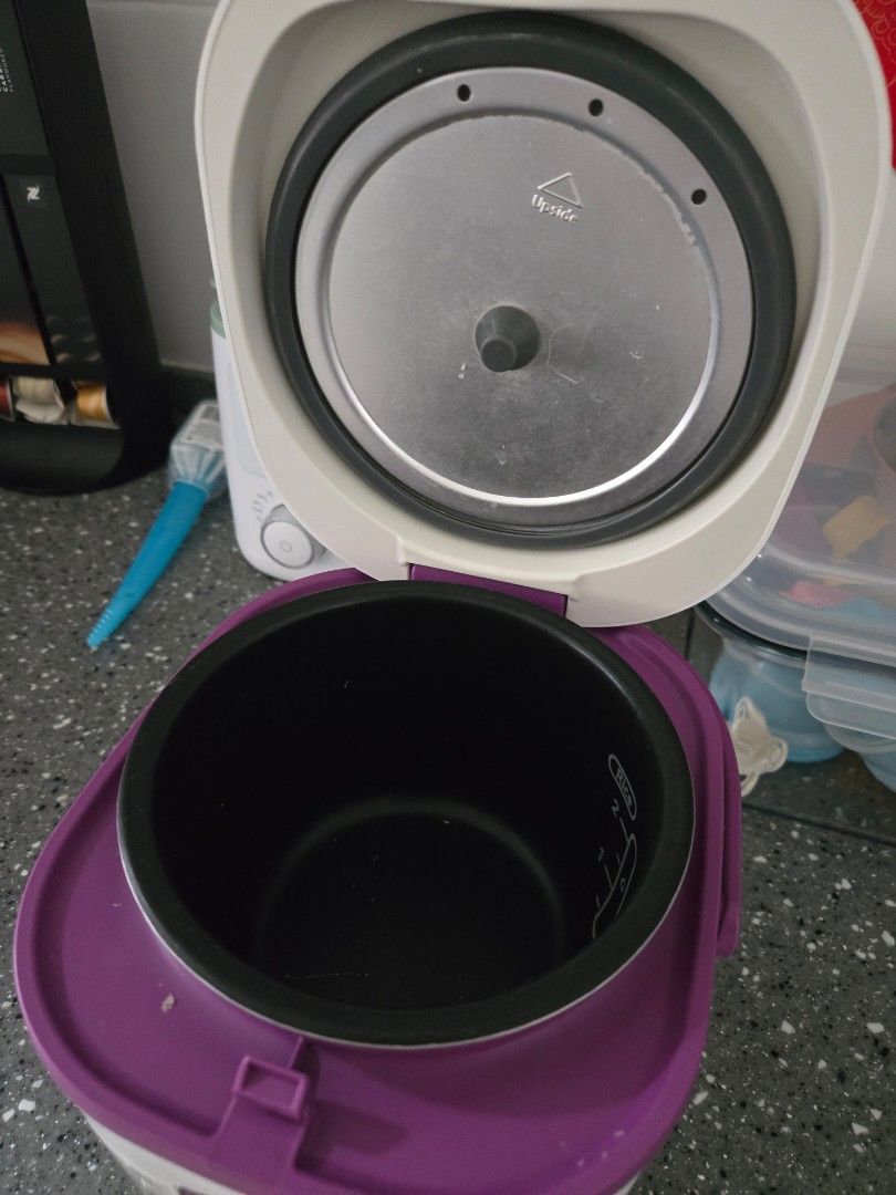 Tefal Mini Rice Cooker (Category: Cookers) located in Puchong. Submitted by redcherrysky (Listing ID 1450174391, Image 3). Description: - Small Tefal rice cooker - White with purple trim - Cook and warm functions - Ideal for small portions - Easy to use - Black inner pot - Lid opens to reveal heating element.