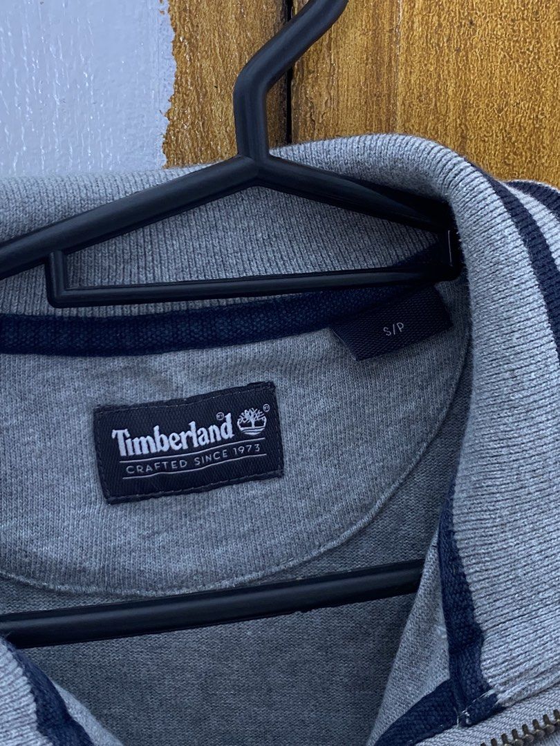 Timberland Grey Half Zip Sweatshirt (Category: Coats, Jackets and Outerwear) located in Meycauayan. Submitted by arkibo (Listing ID 1450308595, Image 2). Description: - Grey Timberland sweatshirt - Half-zip neckline with navy blue striped trim - Small Timberland logo on the chest - Size: S/P - Ideal for casual wear 10/10 pristine condition good for small size .