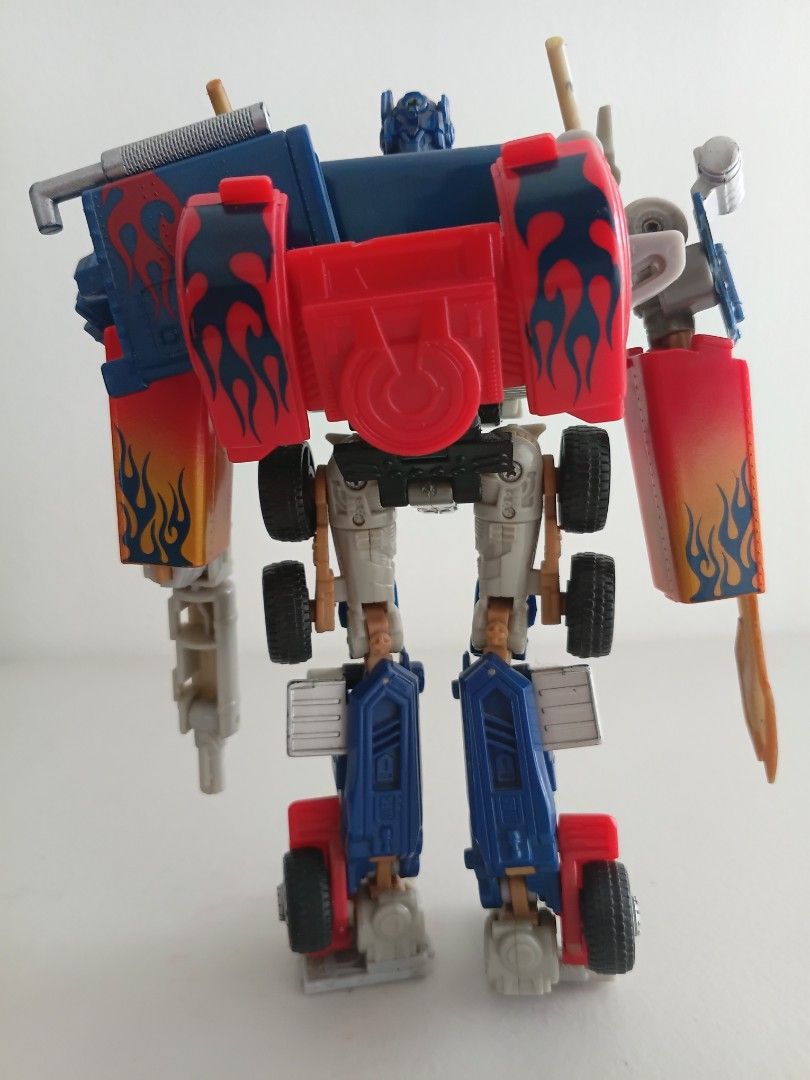 Transformers Optimus Prime Action Figure (Category: Action & Battle Toys) located in Manila. Submitted by dampotmnl (Listing ID 1450200884, Image 2). Description: - Iconic Optimus Prime Transformer toy - Features classic red, blue, and silver colors with flame details - Transforms into a robot - Perfect for Transformers collectors and fans - Solid and durable construction.