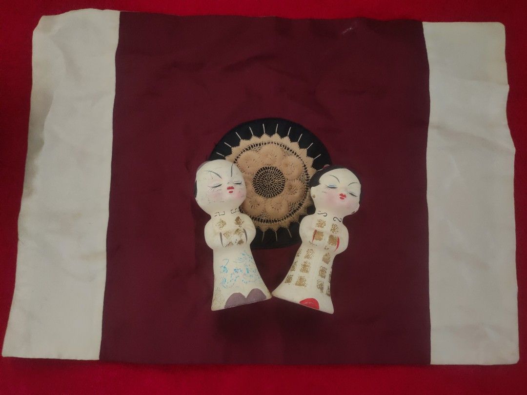 Vintage Decorative Dolls on Fabric Display (Category: Vintage Collectibles) located in Imus. Submitted by jane369 (Listing ID 1450146212, Image 1). Description: - Two cute vintage dolls - Displayed on decorative fabric (maroon center, white borders) - Features a circular embroidered design behind the dolls - Perfect as a unique display piece for your home - Ideal for collectors or as a quirky accent.
