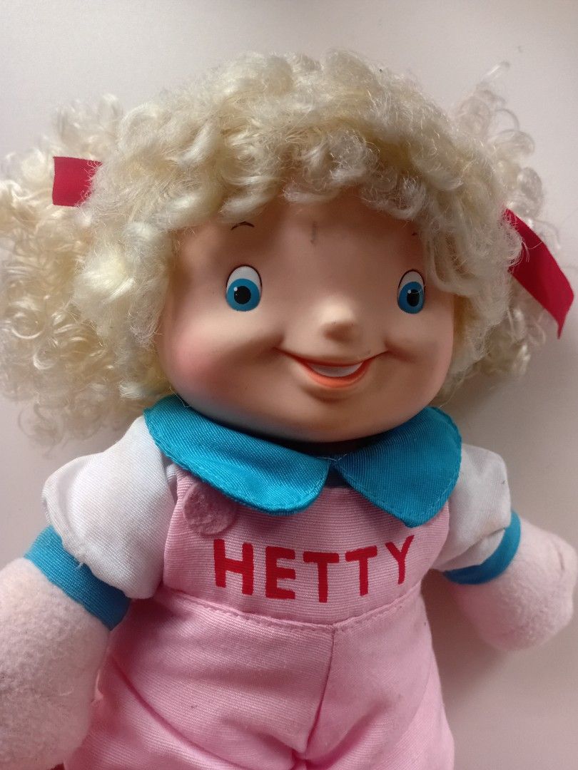 Vintage Jollibee Hetty Doll 1994 (Category: Plushies & Soft Toys) located in Navotas City. Submitted by ms.soulana (Listing ID 1450295876, Image 2). Description: -PreOwned LikeNew Vintage Jollibee Hetty Doll from 1994 - Features a vinyl head and soft plush body - Adorable curly blonde hair adorned with red bows - Pink overalls with 'HETTY' embroidered on the front - Approximately 13 inches tall - Perfect for collectors and Jollibee fans! Great Co