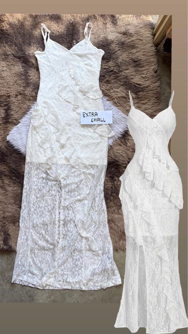 White Lace Ruffle Maxi Dress Spaghetti Straps (Category: Dresses) located in Manila. Submitted by graciouslygraceee (Listing ID 1450242433, Image 3). Description: - Stunning white lace maxi dress - Delicate spaghetti straps - Beautiful ruffled overlay detail - Sheer lace bottom for a dramatic effect - Flattering mermaid/trumpet silhouette - Ideal for formal events, parties, and special occasions - Size: Extra Small (XS).