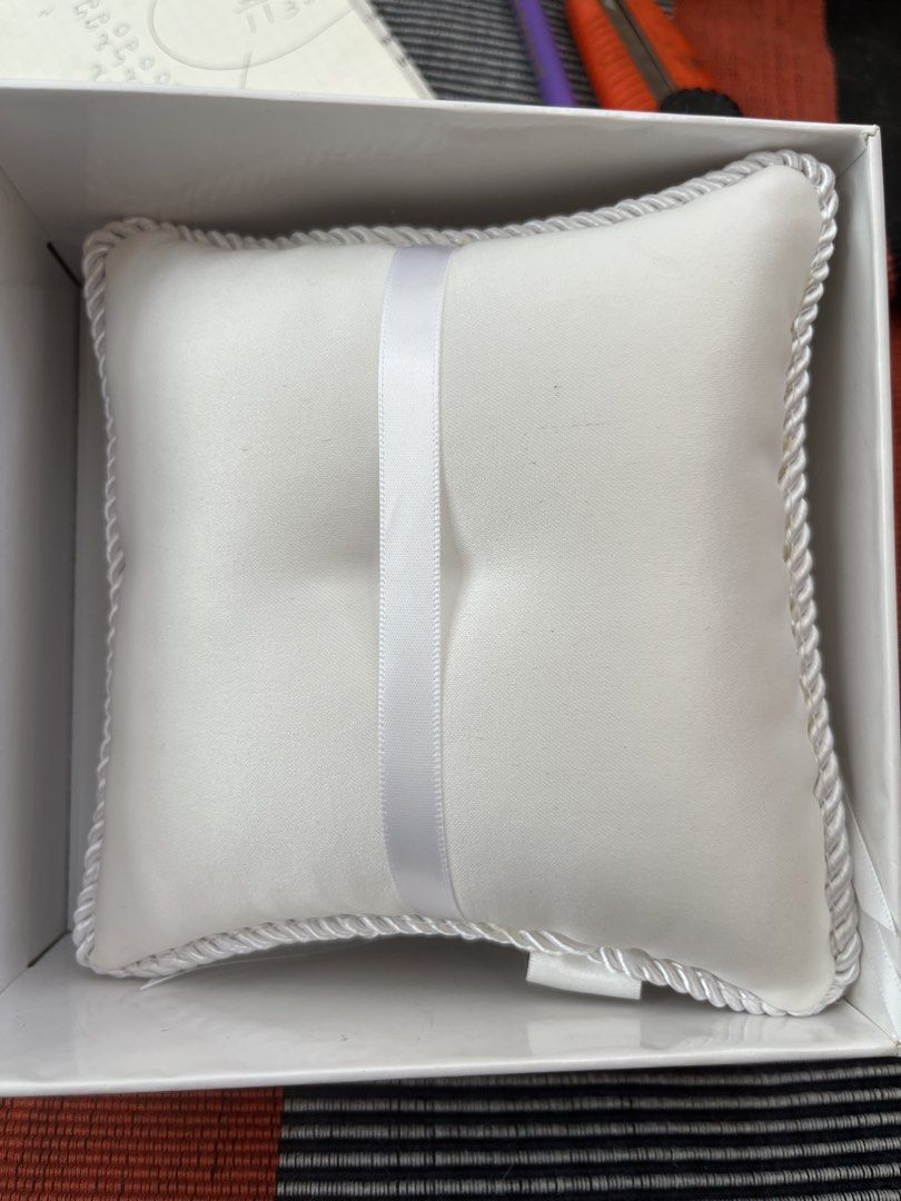 White Ring Pillow with Rosettes and Lace (Category: Bedding & Towels) located in Los Banos. Submitted by profemy (Listing ID 1450221565, Image 3). Description: - Beautiful white ring pillow, perfect for weddings. - Adorned with delicate rosettes and elegant lace trim. - Includes satin ribbons and charming pearl accents. - Designed to beautifully hold your wedding rings. - Comes in its original packaging. Will ship by J& T. Add 60 pesos for shippi