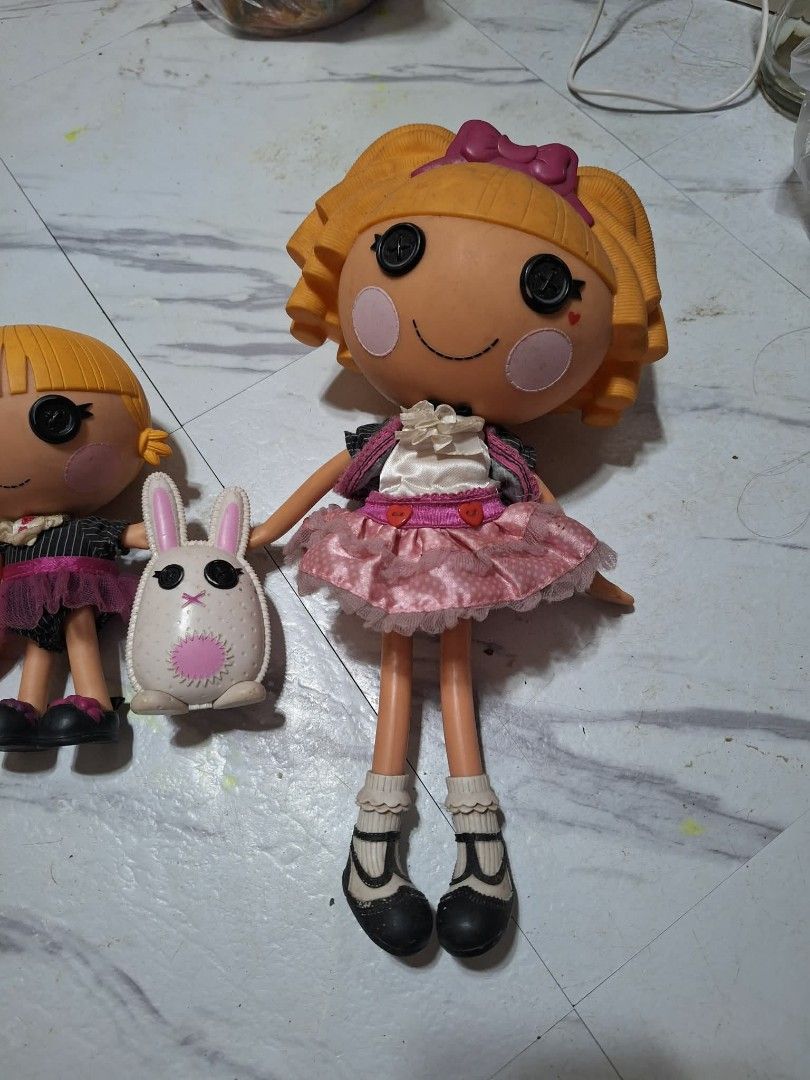 2 Lalaloopsy Dolls with Bunny Accessory (Category: Kids Toys) located in Valenzuela. Submitted by rhian01 (Listing ID 1450330362, Image 2). Description: - Set of two Lalaloopsy dolls - Large doll: blonde curly hair, pink dress - Small doll: blonde hair, black and pink outfit - Includes white bunny accessory - Ideal for Lalaloopsy collectors or playtime fun.