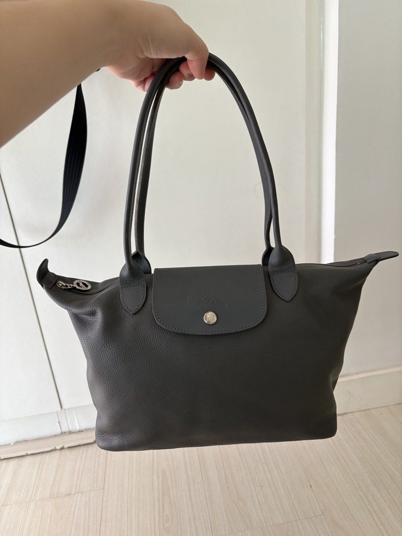 Authentic longchamp leather shoulder bag gray small (Category: Luxury Bags & Wallets) located in Makati City. Submitted by ssofiasellss (Listing ID 1450346936, Image 1). Description: Minimal signs of use Real leather Color: gray Guaranteed original from Paris Selling for a quarter of purchase price Rfs: decluttering Comes with longchamp paper bag.