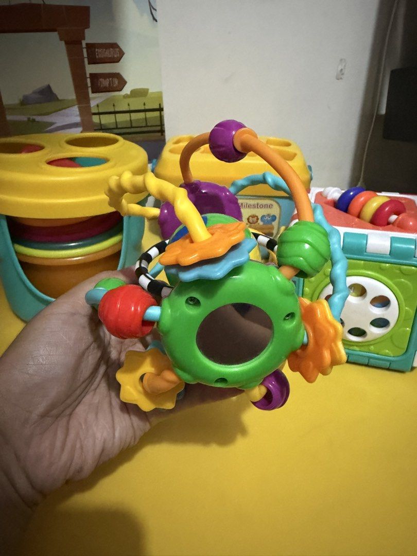 Baby Activity Toys Bundle - Stacking Cups, Shape Sorter, Activity Cube (Category: Infant Playtime) located in Pasig City. Submitted by etcyshop (Listing ID 1450348605, Image 2). Description: Preloved Batch 1 Kids educational toys for 18mos- 3y/o Item #1 Little Learner Activity Sensory Ball- colorful developmental toy featuring a central spinning face and easy-grasp textured rings. 150 Item #2 6-sided activity cube, designed to help toddlers devel