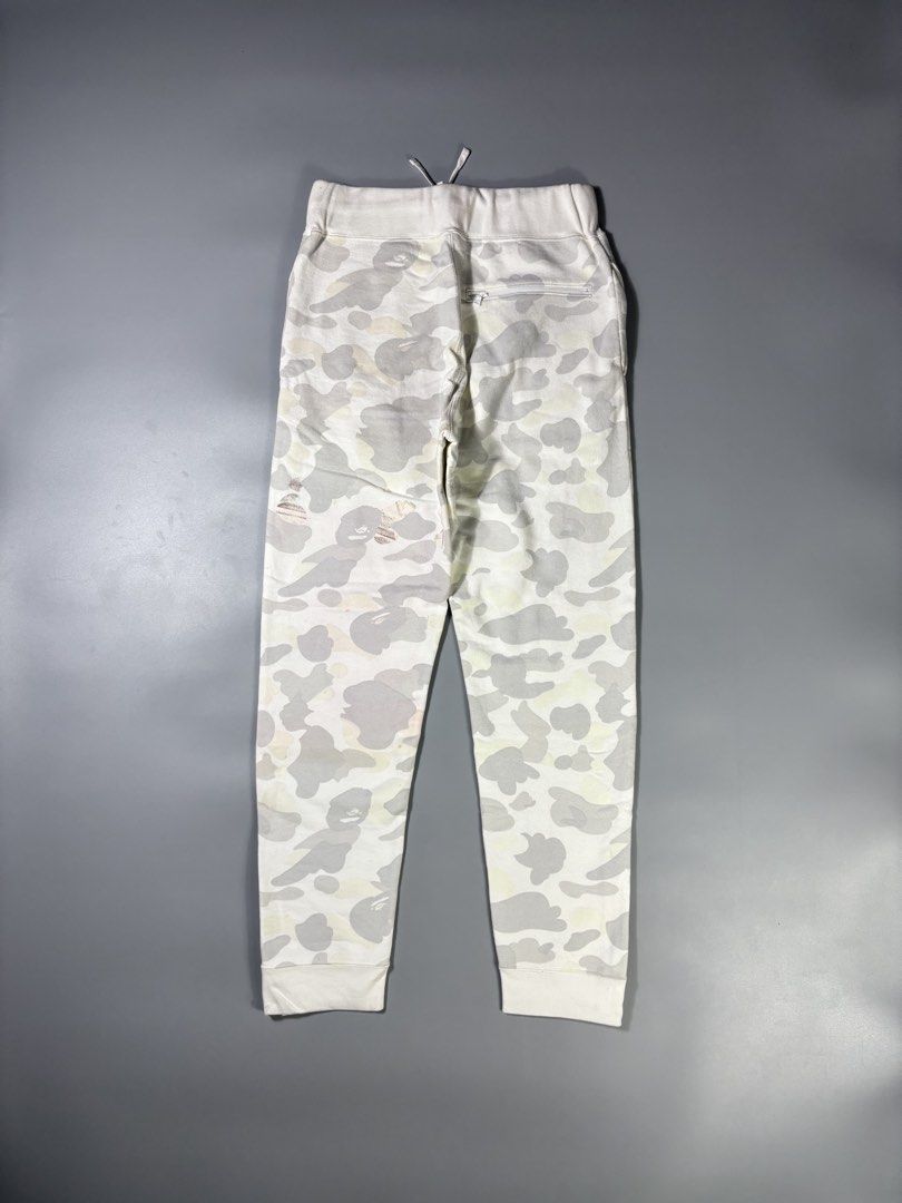 Bape Side Script “Glow in The Dark” Gray Camou SweatPants (Category: Joggers) located in Manila. Submitted by whowearsstreetwear (Listing ID 1450498786, Image 2). Description: Bape Side Script “Glow in The Dark” Gray Camou SweatPants (Authentic) - Size: Small on tag (measurements in inches) W - 28 - 34 L - 40 Condition: Very Good Flaw/s: stains (check pics) + shipping fee Location: Manila (Near UST) .
