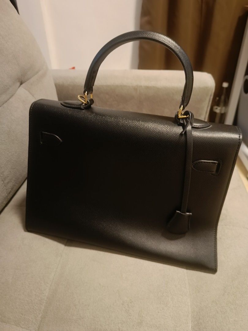 Black Leather Handbag with Gold Hardware (Category: Luxury Bags & Wallets) located in Davao. Submitted by clecle1 (Listing ID 1450432856, Image 3). Description: - Classic black leather handbag - Structured design with top handle - Elegant gold-tone hardware - Secure lock and key closure - Interior zippered pocket and compartments - Versatile for daily use or special occasions - A timeless, must-have accessory.