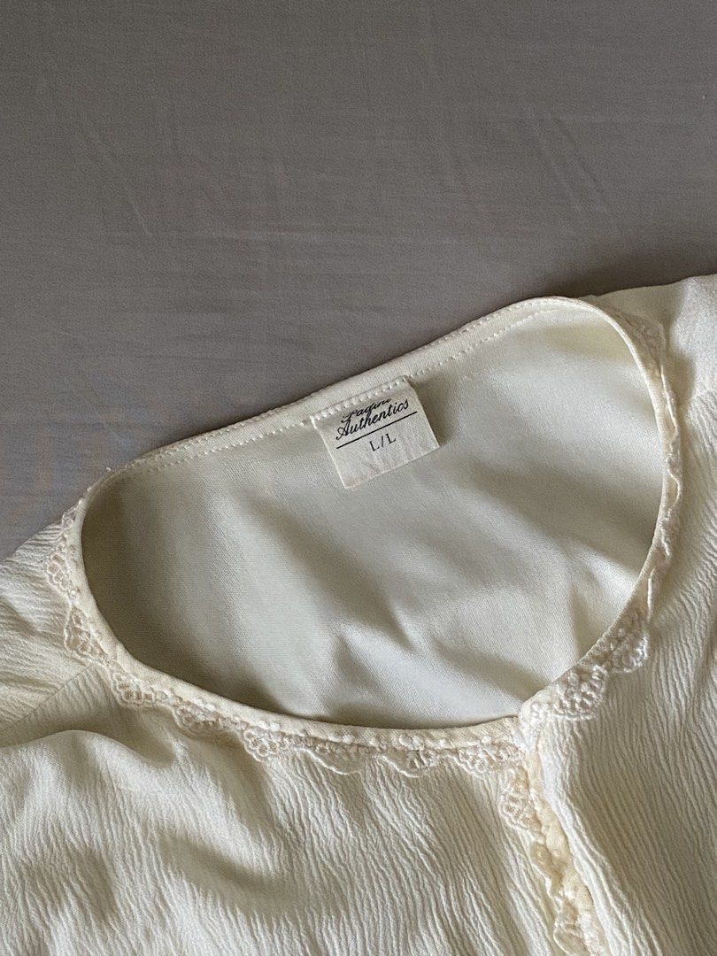 blouse (Category: Blouses) located in Kuala Lumpur. Submitted by syeraaicah (Listing ID 1450351597, Image 3). Description: - Brand:padini - Color: Cream - Style: Long sleeve top - Features: Button detail at neckline, lace trim, cuffed sleeves - Fabric: Lightweight with a crinkled texture.