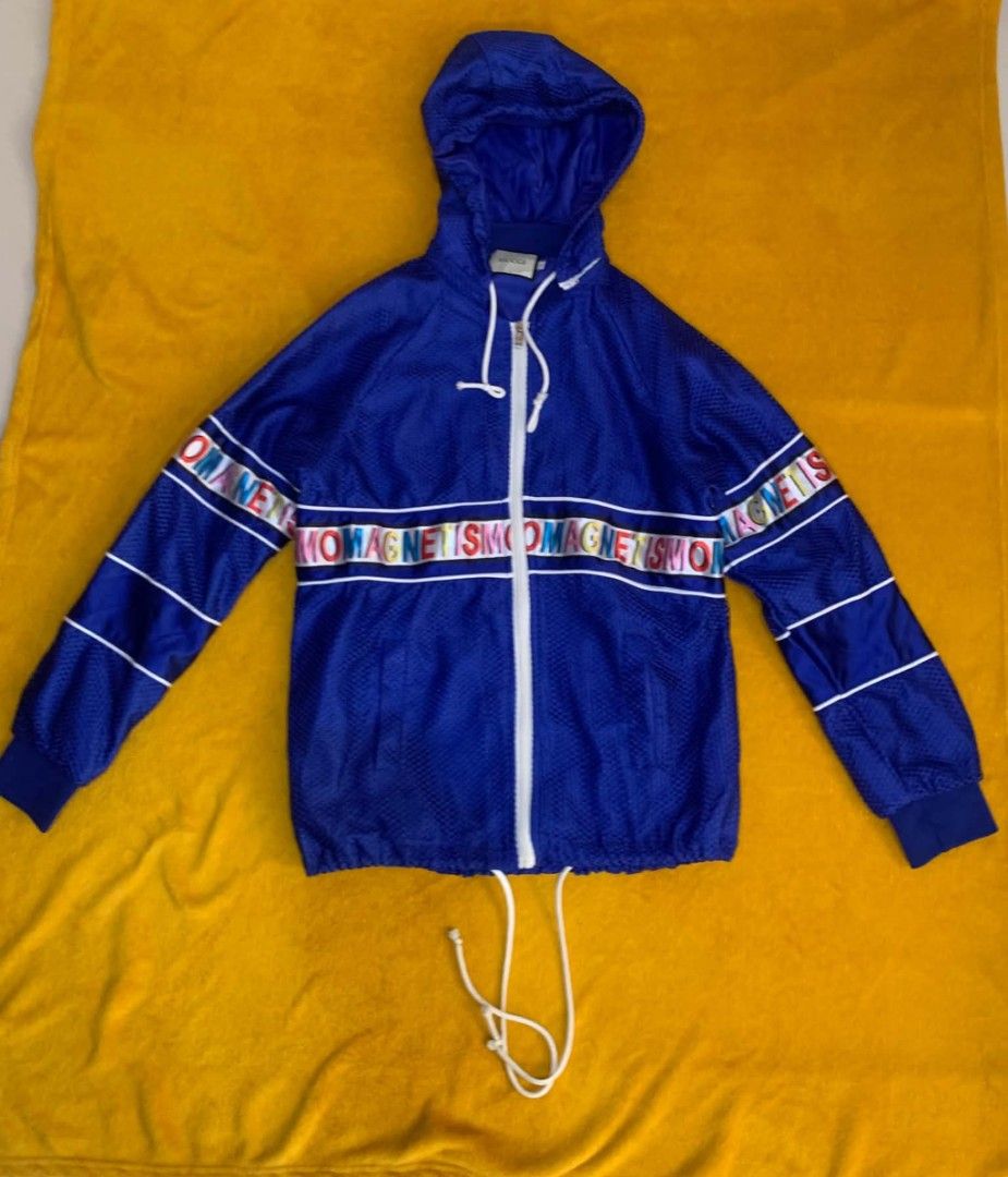 Blue Mesh Tracksuit Set with "MAGNETISMO" Logo (Category: Sets & Coordinates) located in Cabuyao City. Submitted by burberrymaki (Listing ID 1450340102, Image 2). Description: - Blue mesh tracksuit set large ot tag fit to small to medium - Jacket features a hood and zip-up front - Shorts have a drawstring waist - Both pieces have a colorful "MAGNETISM" logo band - Ideal for casual wear or sports.