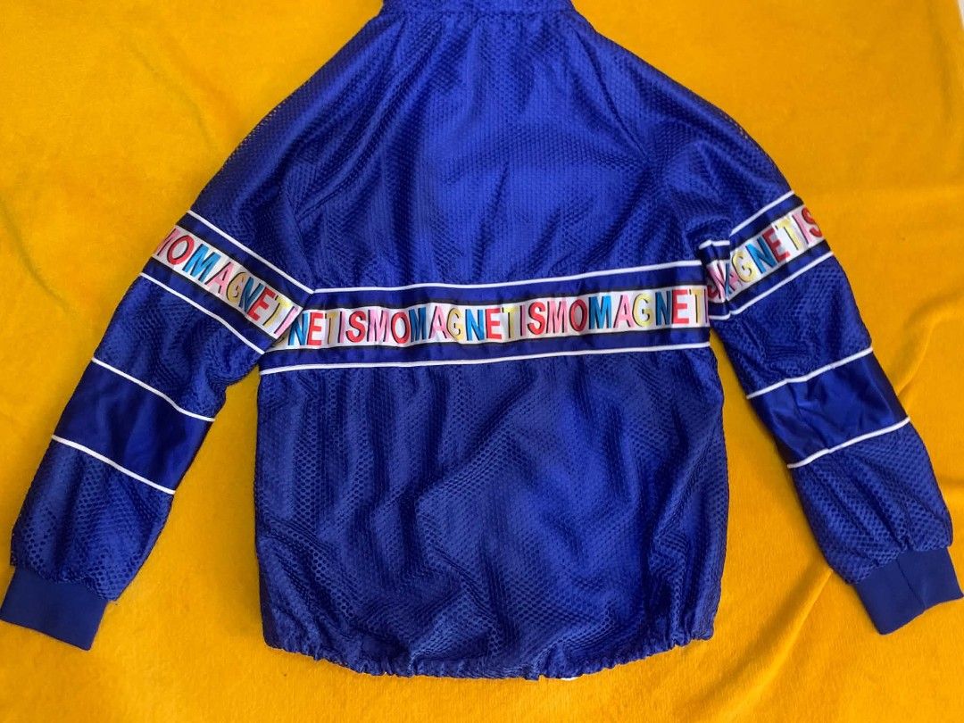 Blue Mesh Tracksuit Set with "MAGNETISMO" Logo (Category: Sets & Coordinates) located in Cabuyao City. Submitted by burberrymaki (Listing ID 1450340102, Image 3). Description: - Blue mesh tracksuit set large ot tag fit to small to medium - Jacket features a hood and zip-up front - Shorts have a drawstring waist - Both pieces have a colorful "MAGNETISM" logo band - Ideal for casual wear or sports.