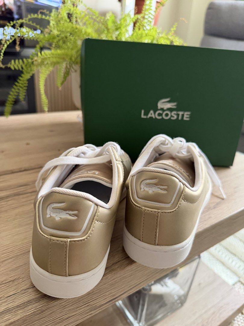 Brand New Lacoste Carnaby Evo Gold Sneakers (Category: Sneakers) located in Paranaque City. Submitted by preloveditems111 (Listing ID 1450408607, Image 2). Description: - Gold Lacoste Carnaby Evo sneakers - Size: 5 US / 37 EUR - Includes original box - Super cute and shiny design - Ideal for casual wear.