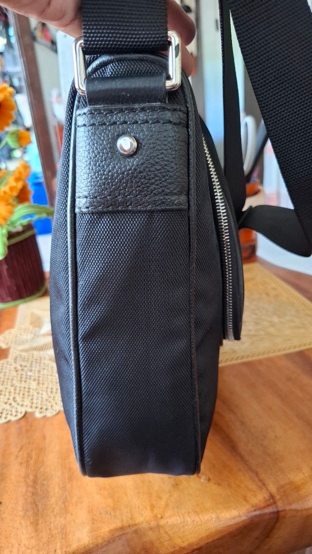 CALVIN KLEIN Black Messenger Bag with Adjustable Strap (Category: Luxury Bags & Wallets) located in Libon. Submitted by jaladzarmi80045 (Listing ID 1450347801, Image 3). Description: - Durable textured black messenger bag - Main zippered compartment - Adjustable shoulder strap - Small leather tag accent - Spacious interior - Ideal for everyday use or travel.