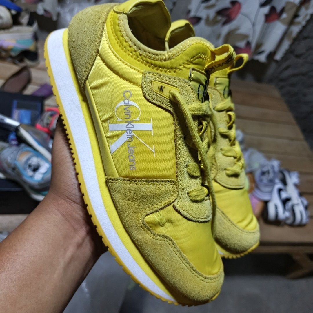 Calvin Klein Jeans Yellow Sneakers (Category: Sneakers) located in Lala. Submitted by ryban91 (Listing ID 1450491470, Image 2). Description: - Yellow Calvin Klein Jeans sneakers - Features classic CK logo on side and heel - Matching yellow laces - Soles branded with Calvin Klein Jeans - Ideal for everyday casual wear.